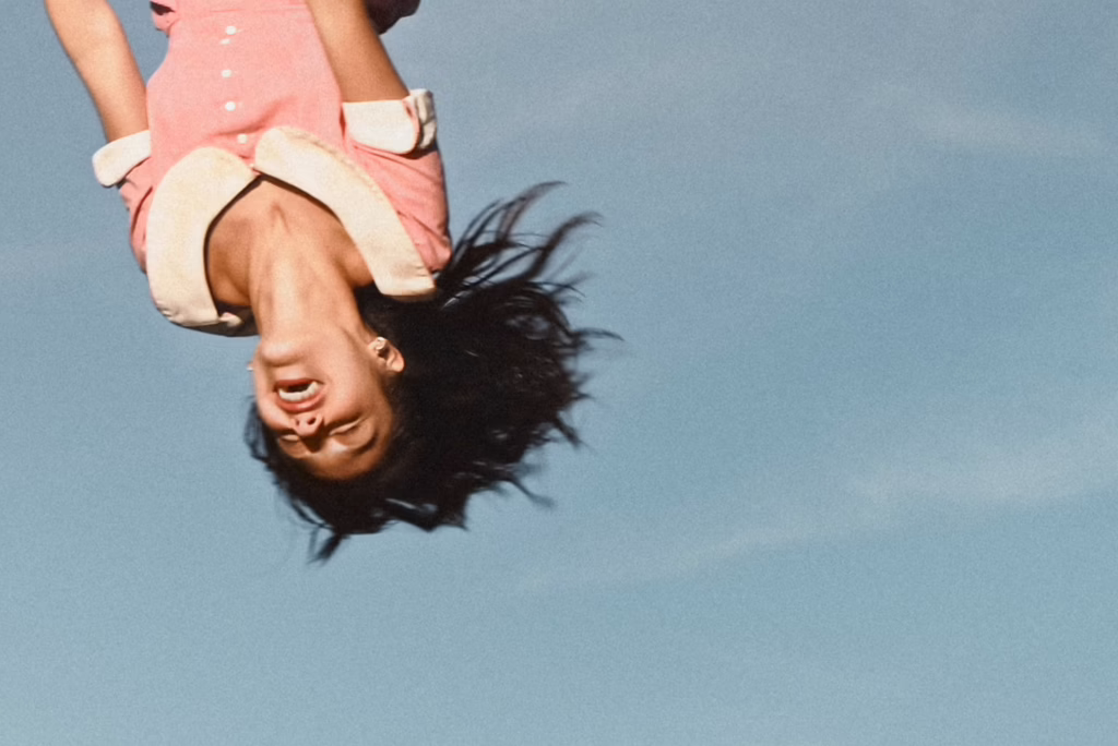 Olivia Rodrigo upside down on swing
