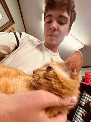 A student holds a cat