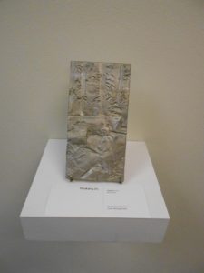 Piece of aluminum art entitled Hatchet depicting forest scene