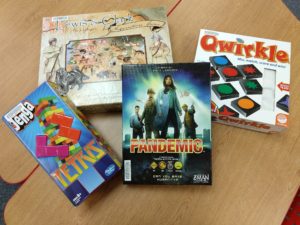 Four board games from the TMC collection: Lewis and Clark, Jenga Tetris, Pandemic, and Qwirkle